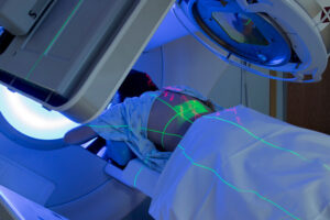 A patient receives a dose of radiation while lying down