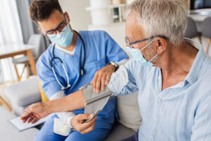 Doctor takes patient's blood pressure