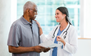 A female doctor meets with an older male patient