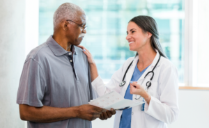 A female patient puts her arm on an older male patient