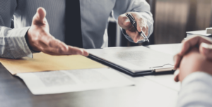 A lawyer reviews documents with client