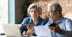 a couple looking over documents and a computer