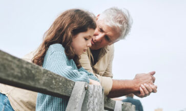 Grandfather talking to granddaughter