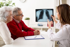 Doctor showing X-rays to senior couple